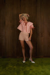 Front view of Pink Bloom cotton bloomers with elastic smocking and softly ruffled hems.
